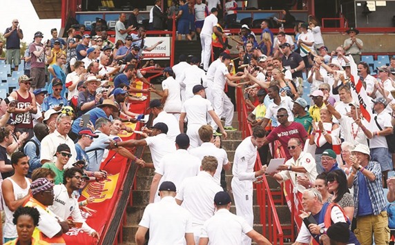 England players sign autographs on their way back to the dressing room, after losing the fourth Test to South Africa in Centurion on Tuesday. England, though, won the series 2-1.