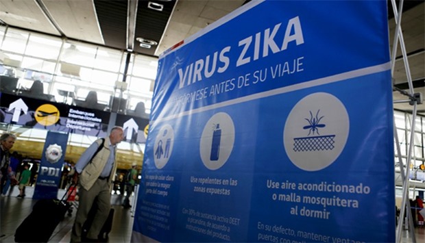 A banner is seen during an information campaign on Zika virus at the departures area of Santiago's i
