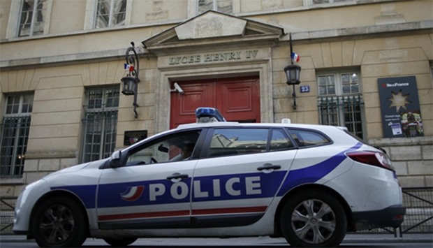 A French police car is seen outside the Lycee Henri IV after police intervened at Paris high schools