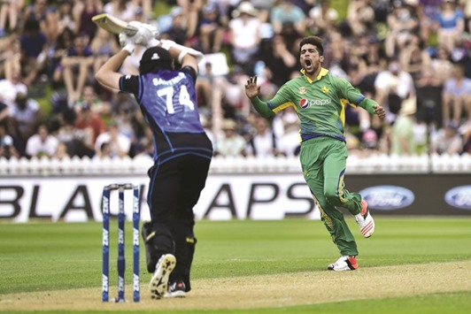 Pakistanu2019s Mohamed Amir calls for a catch on Mitchell Santner (left) of New Zealand during the first ODI at Basin Reserve in Wellington on Monday. (AFP)