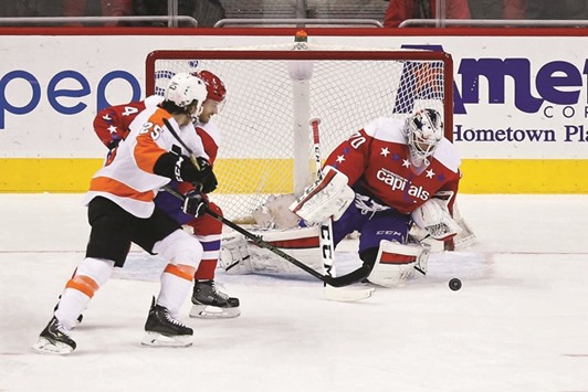 Washington Capitals goalie Braden Holtby makes a save in front of Philadelphia Flyers center Ryan White (No 25) in the first period at Verizon Center. PICTURE: USA TODAY Sports