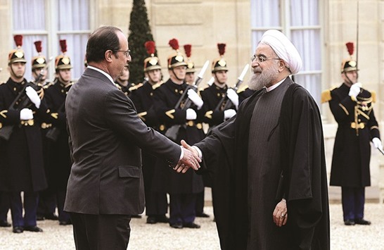 French President Francois Hollande welcomes Iranian President Hassan Rouhani at the Elysee Presidential Palace in Paris.