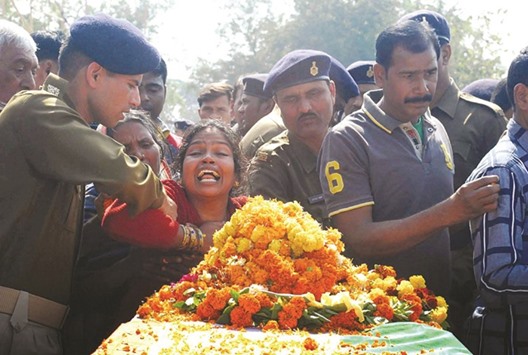 A woman cries over the coffin of a policeman killed in a suspected Maoist attack in the Palamau district of Jharkhand yesterday.