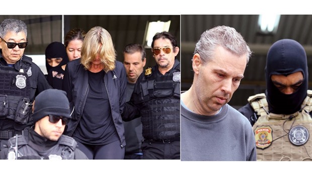 Publicist Nelci Warken (left) and Ricardo Honorio Neto of Panama-based Mossack Fonseca Group (right) are escorted by federal police officers as they leave the Institute of Forensic Science in Curitiba.