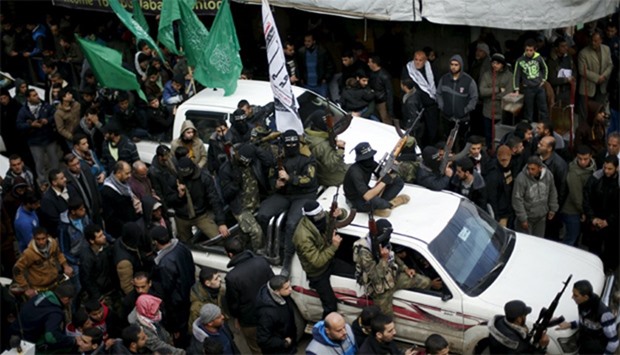 Palestinian Hamas gunmen attend the funeral of their seven comrades who were killed when a tunnel co