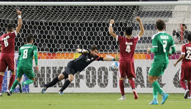 Qatar's goalkeeper Muhannad Naim (C) tries to save a shot during their AFC U23 Championship 3rd plac