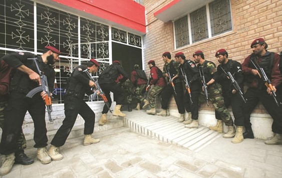 Special combat police conducting an exercise to repel militant attacks enter Elizabeth High School in Peshawar.