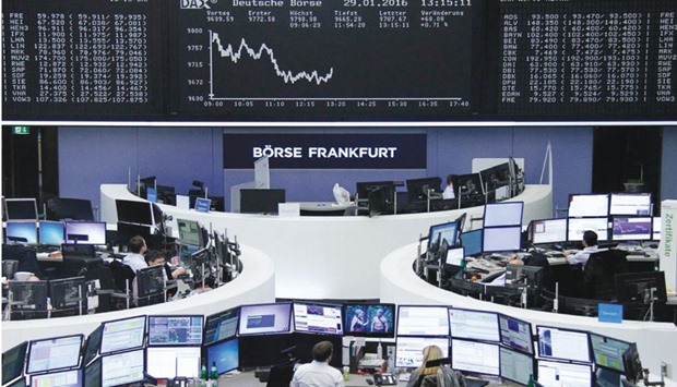 Traders work at the stock exchange in Frankfurt. The DAX 30 was up 1.6% at 9,798.11 points at close yesterday.