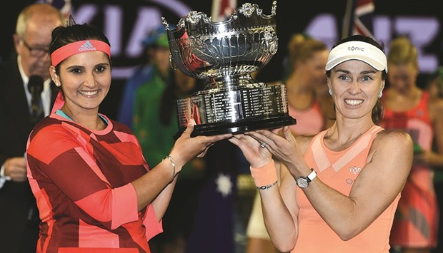 Sania Mirza (L) and Martina Hingis (R) pose with  the trophy after they beat Lucie Hradecka and Andrea Hlavackova in the final.