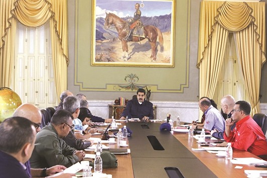 Venezuelau2019s President Nicolas Maduro (centre) attends a meeting with ministers at Miraflores Palace in Caracas.