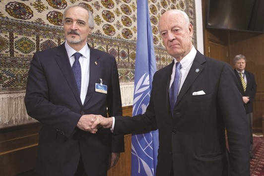 Syrian ambassador to the UN and head of the government delegation Bashar al-Jaafari (left) shakes hands with UN envoy Staffan de Mistura at the opening of the talks in Geneva yesterday.