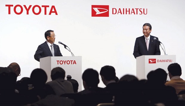 Toyota president Akio Toyoda (left) speaks next to Daihatsu president Masanori Mitsui during a joint news conference in Tokyo yesterday. The companies intend to develop Daihatsu into a global brand as they focus on growing markets for compact cars.