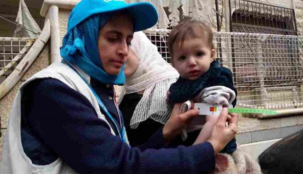 A UNICEF Nutrition Specialist takes a child's mid-upper arm circumference in Madaya, Syria.
