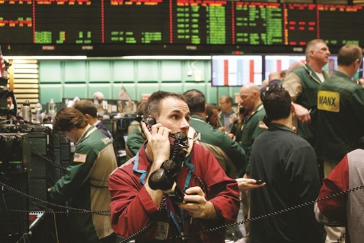 A trader works in the crude oil  options pit on the floor of the New York Mercantile Exchange. For the week ended on Friday, Brent was 7.9% higher and US crude 4.4% higher, paring their monthly losses to 6.8% and 9.3% respectively.