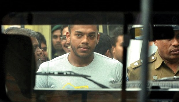 Former president Mahinda Rajapakseu2019s second son Yoshitha Rajapakse being taken in handcuffs after he was remanded in custody for two weeks in Kaduwela, near Colombo, yesterday.