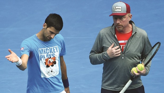 Serbiau2019s Novak Djokovic (L) gestures as he speaks with his coach Boris Becker during a training session in Melbourne yesterday.