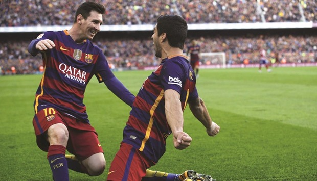 Barcelonau2019s Luis Suarez (right) celebrates with teammate Lionel Messi  after scoring a goal  yesterday. (Reuters)