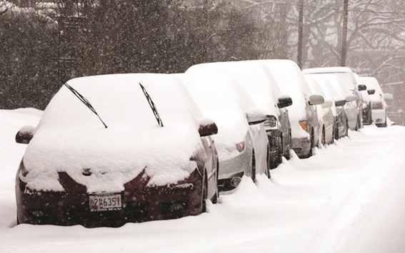 BLANKETED: Snow-covered parked cars in Old Southwest Roanoke, Virginia last week.