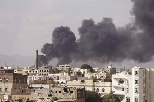 Smoke billows from a site hit by Saudi-led air strikes in Sanaa yesterday.