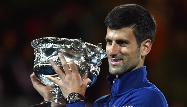 Serbia's Novak Djokovic holds the winner's trophy after defeating Britain's Andy Murray in their men's singles final at the 2016 Australian Open in Melbourne on Sunday.