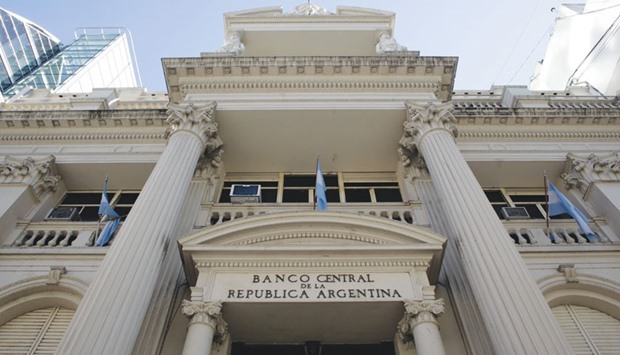 Flags fly outside the central bank of Argentina in Buenos Aires. The one-year loan, finalised with seven Wall Street banks on Friday, will be backed by sovereign bonds, according to an e-mailed statement from the central bank.