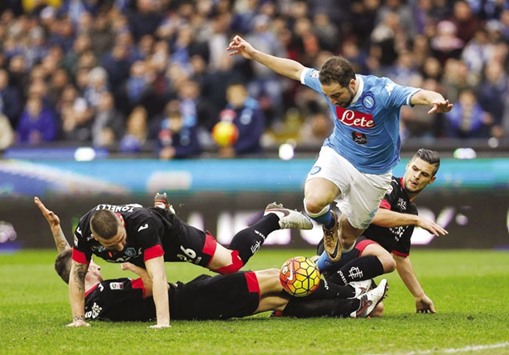 Napoliu2019s Gonzalo Higuain (centre) is tackled by Empoliu2019s Michele Camporese, Vincent Laurini (right) and Lorenzo Tonelli (second left). (Reuters)