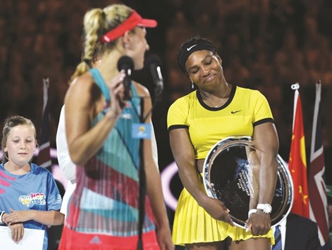 Angelique Kerber (L) looks back towards Serena Williams as she celebrates after victory in her Australian Open womenu2019s singles final.