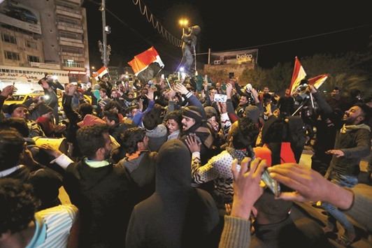Fans in Baghdad celebrate after Iraq qualified for the Olympics, by finishing third at the AFC U23 Championship in Doha. (Reuters)