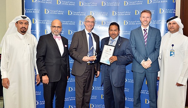 Seetharaman and senior Doha Bank officials receiving the awards.