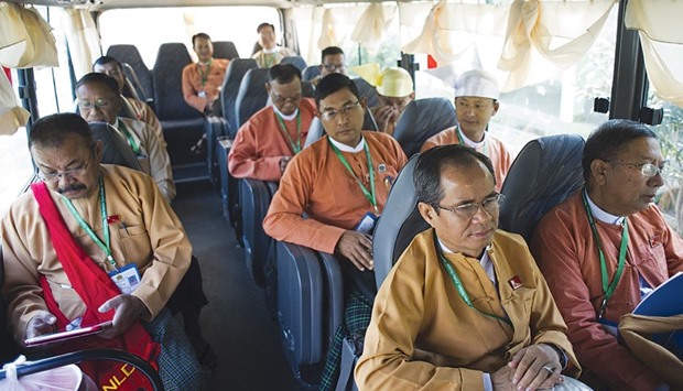 Newly-elected National League of Democracy (NLD) members of parliament sit in a bus as they depart the city development committee compounds for parliament in Naypyidaw.