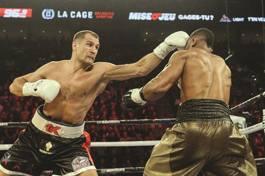 Sergey Kovalev (left) of Russia lands a jab on Jean Pascal of Canada during the WBO, WBA, and IBF light heavyweight world championship match in Montreal on Saturday. (AFP)