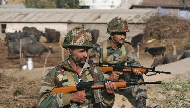 Indian army soldiers stand guard near the Indian Air Force base at Pathankot on Sunday.
