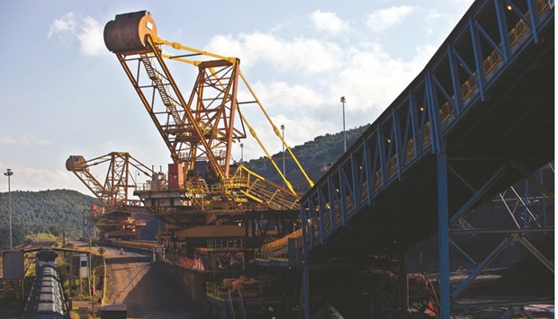 Crushed iron ore fills cargo train wagons aside a conveyor belt at Valeu2019s iron ore Brucutu mine in Brazil. Iron ore has lost 39% last year, extending 2014u2019s 47% plunge and the 8.3% retreat in 2013, according to Metal Bulletin data.