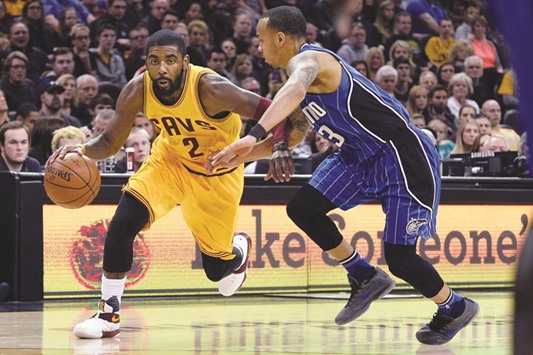 Cleveland Cavaliers guard Kyrie Irving (2) drives past Orlando Magic guard Shabazz Napier (13) during the second quarter of their game at Quicken Loans Arena on Saturday.