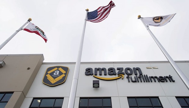 Amazon.com signage is displayed on the facade of the companyu2019s fulfilment centre in Tracy, California. The tech-savvy retailer is considering leasing 20 Boeing Co 767 freighter jets to help gain more control over its delivery methods and costs.