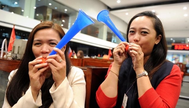 Traders at the Philippine Stock Exchange blow horns to mark the first day of trading for 2016 in Manila on Monday.  Asian stock markets tumbled while oil prices jumped in the first full day's trade of 2016 as a flare-up in tensions between Iran and Saudi Arabia raised concerns.