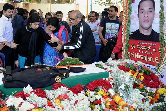 E K Sivaranjam, father of slain National Security Guard commando Lieutenant Colonel Niranjan Kumar, who died while defusing a grenade at the scene of the terror attack in Pathankot, consoles his daughter-in-law  K G Radhika (second left) after the arrival of Kumaru2019s mortal remains at his residence in Bengaluru yesterday.