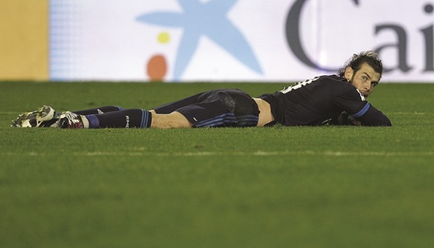 Real Madridu2019s Welsh forward Gareth Bale lies on the pitch after a failed attempt on goal during the Spanish league match between Valencia and Real Madrid in Valencia.