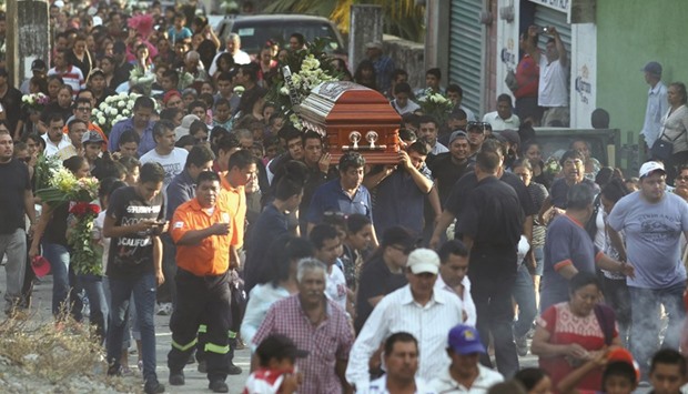 Residents and relatives carry the coffin of newly-installed Temixco mayor, Gisela Mota, along the streets during her funeral in Temixco.