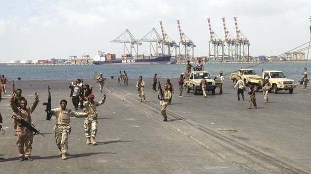 Army soldiers celebrate after taking over the main port of Yemenu2019s southern city of Aden from gunmen, yesterday.