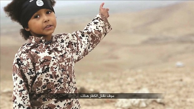 A child speaks in this still image from a handout video obtained yesterday from a social media website which has not been independently verified. Britain was yesterday examining the Islamic State video showing the boy in military fatigues and an older masked militant who both spoke with British accents.