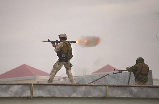 An Afghan Quick Reaction Force (QRF) soldier fires a rocket-propelled grenade (RPG) launcher during an operation near the Indian consulate in Mazar-i-Sharif yesterday.