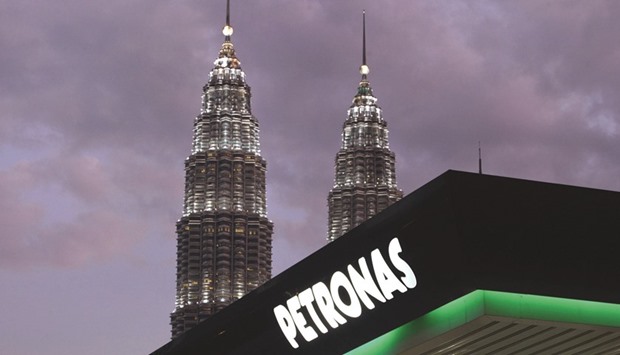 Petronas signboard is lighted at night in Kuala Lumpur. The Malaysian fuel  company will focus this year on managing inventories to help cut operating costs and sustain dividend payments as it anticipates continued oil market turmoil.