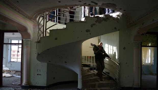 An Afghan security force personnel walks inside a building used by insurgents to launch an attack on the Indian consulate, in Mazar-i-Sharif on Tuesday. A 25-hour siege near the Indian consulate ended late on Monday.