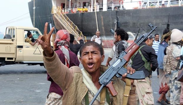 Fighters loyal to Yemen's President Abedrabbo Mansour Hadi celebrate after they managed to secure completely and take control of Aden on Monday.