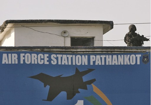 A soldier stands guard on a building at the Indian Air Force (IAF) base at Pathankot yesterday.