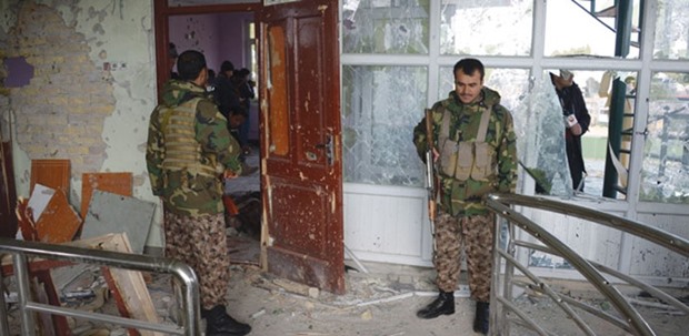 Afghan security force personnel inspect a building used by insurgents to launch an attack on the Indian consulate, in Mazar-i-Sharif yesterday.
