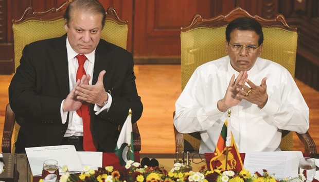 Nawaz Sharif, left, and Maithripala Sirisena applaud during a meeting at the Presidential Secretariat in Colombo yesterday.