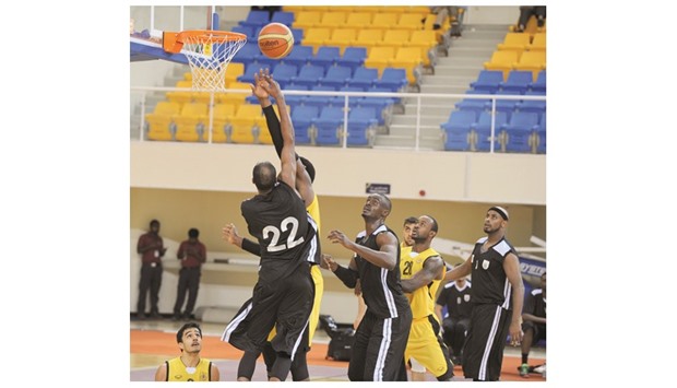 Action from the Qatar Basketball League match between Al Sadd (in black) and Qatar Sports Club at Al Gharafa Sports Club yesterday. PICTURES: Othman Iraqi