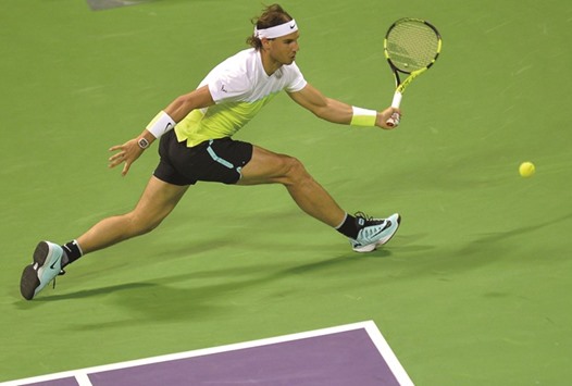 Spainu2019s Rafael Nadal reaches out for a return during the Qatar ExxonMobil Open first round match against compatriot Pablo Carreno Busta at the Khalifa International Tennis and Squash Complex here yesterday.